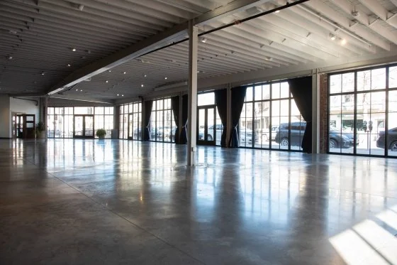The former garage, now an open event hall with a wall of steel windows