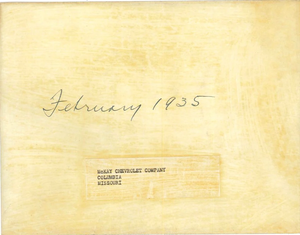 Back of the photo, handwritten February 1935 with a typed McKay Chevrolet Company label