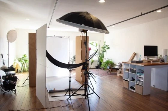 Photography studio with lights and backdrop on wood floors