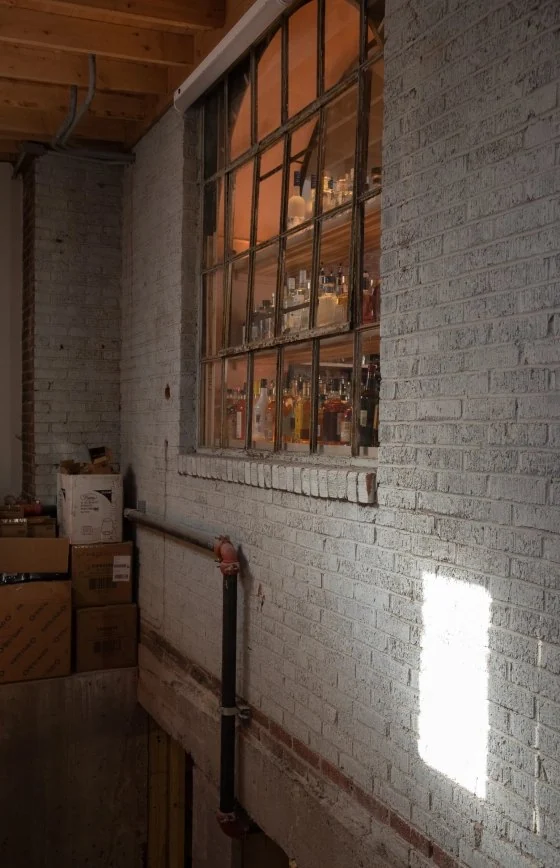 Painted brick wall with a steel window above a stair